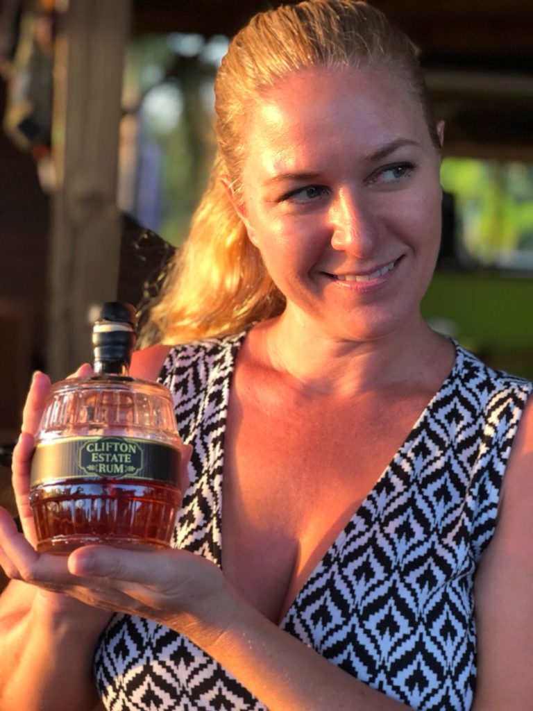 JenThereDoneThat holding a bottle of Clifton Estate Rum