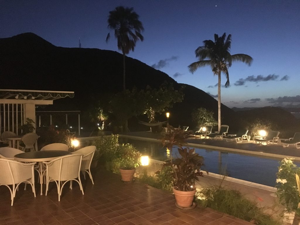 Mount Nevis Hotel Pool at Night with ample seating, lounge chairs, hammocks, and plenty of lights.